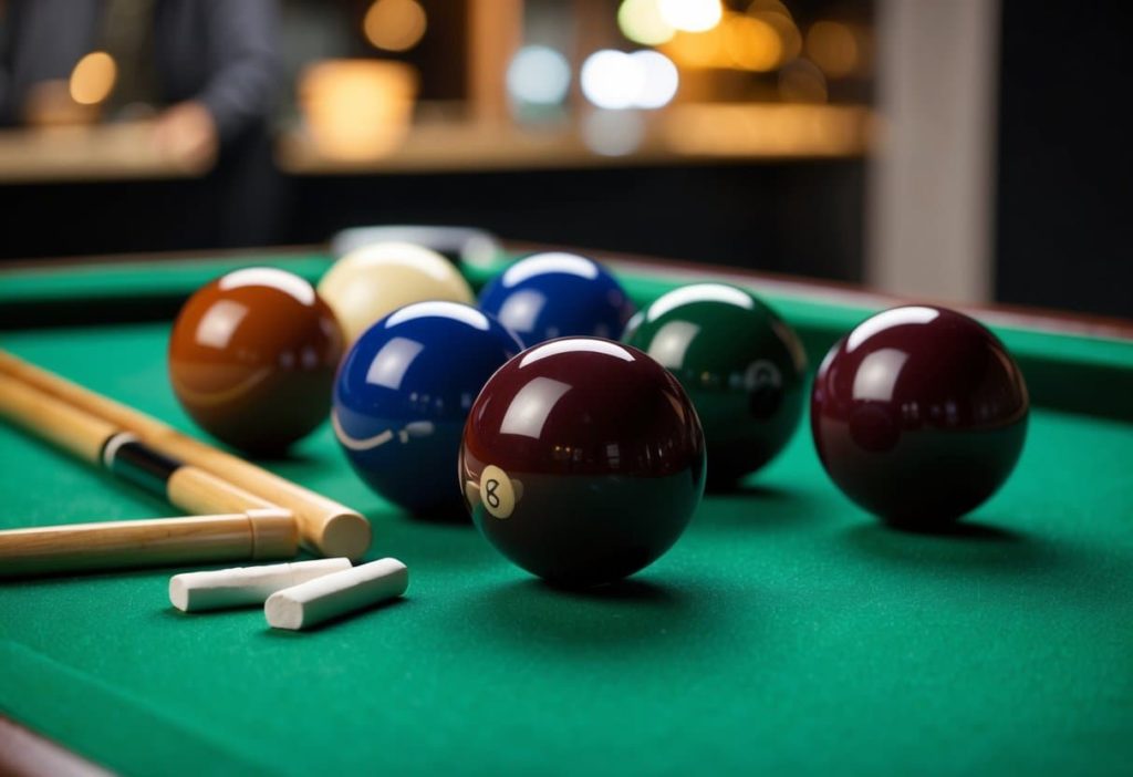 cues balls and chalk on a pool table