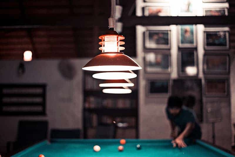 pool table lights with player in background