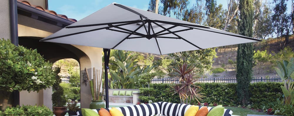 Cantilever umbrella set up in lush green backyard
