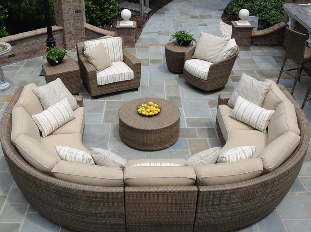 rounded sofa is one of the outdoor fireplace seating ideas