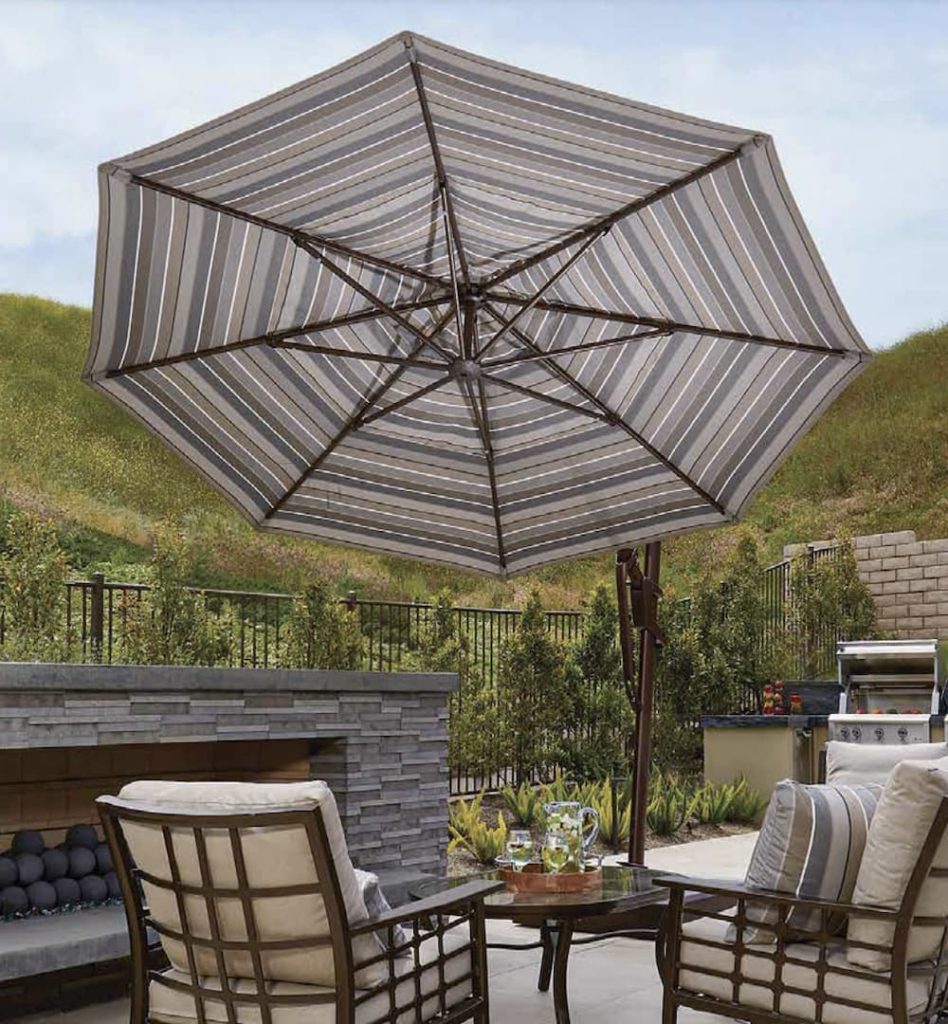 cantilever umbrella positioned over an outdoor conversation set