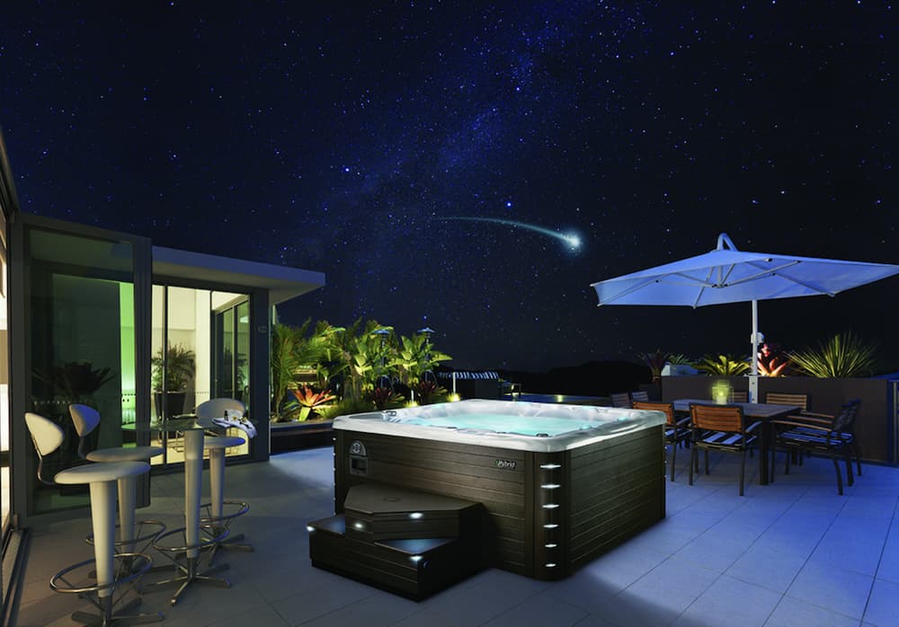 Shooting star over hot tub at night