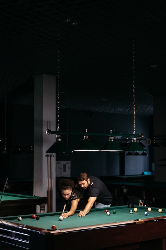 Billiard lights with chains hanging straight from the ceiling