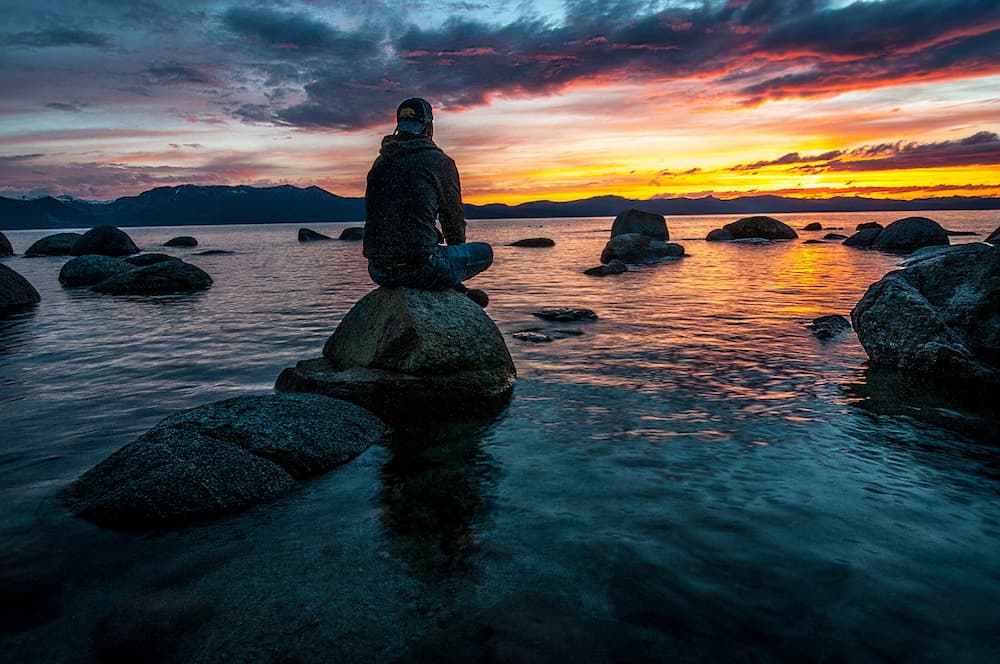 being mindful includes watching sunsets on the water and reduces stress and anxiety